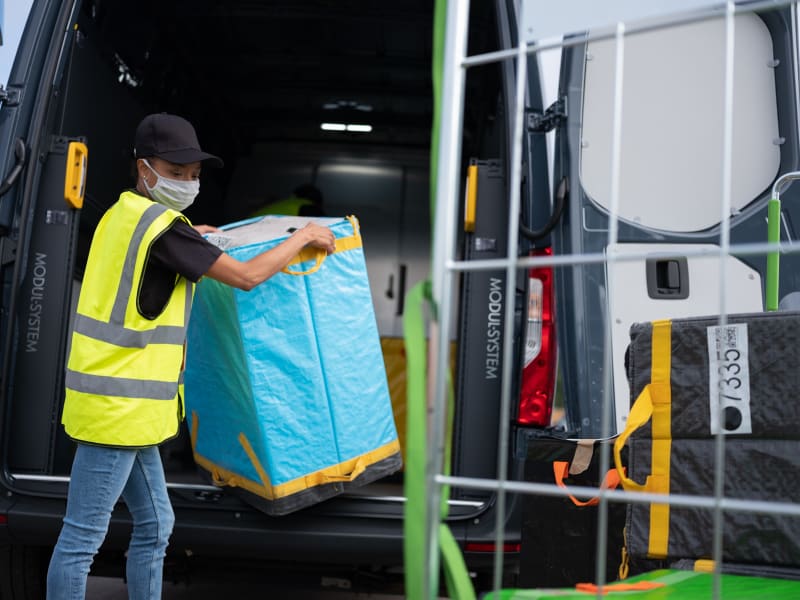 Delivery driver unloading a van